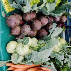 assorted fresh ripe vegetables in market stall